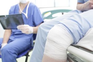 person with injured knee at doctor